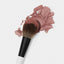 Larger side of the Makeup By Mario's F3 Dual-Ended Precision Powder Brush dipped in powder blush.